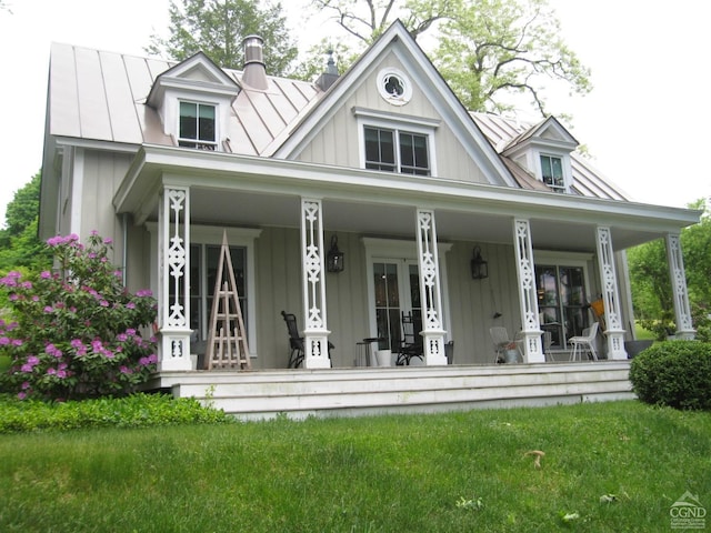 view of front of property featuring a porch, board and batten siding, and a standing seam roof