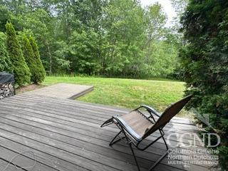 wooden terrace with a lawn