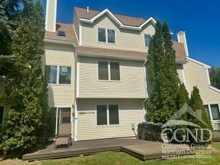 rear view of property with a wooden deck