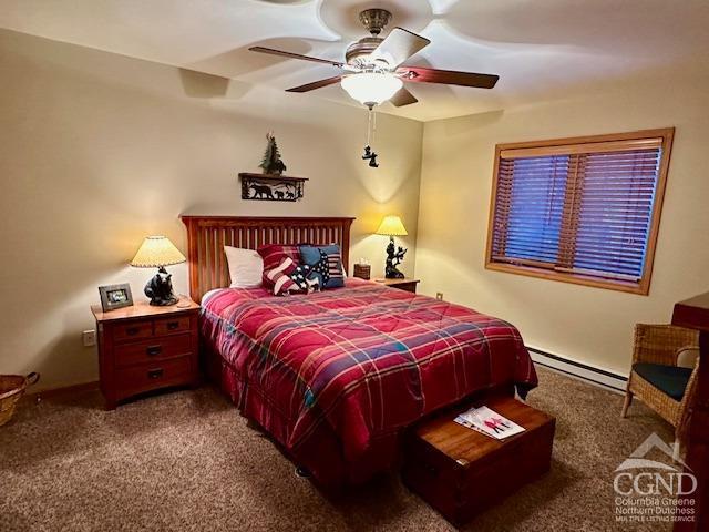 carpeted bedroom featuring ceiling fan and a baseboard radiator