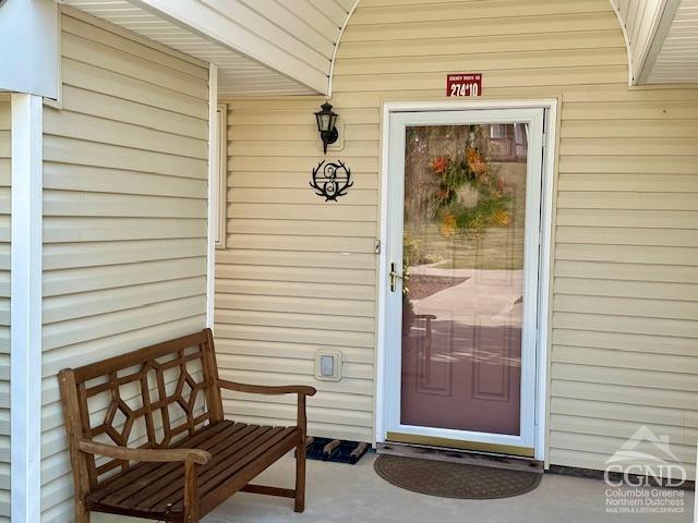 view of exterior entry with covered porch