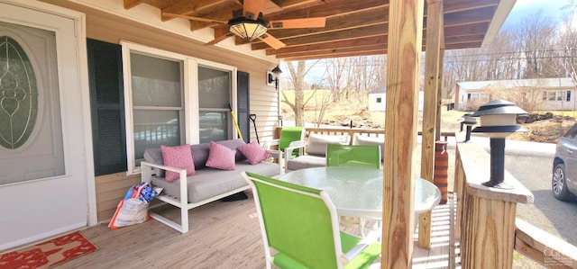 wooden terrace featuring a ceiling fan