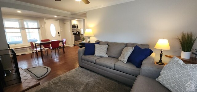 living area with wood finished floors, recessed lighting, ornamental molding, and ceiling fan