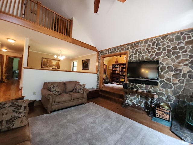 living room featuring hardwood / wood-style floors, high vaulted ceiling, and ceiling fan with notable chandelier