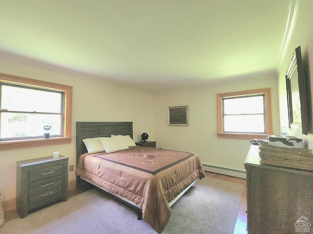 bedroom featuring multiple windows, crown molding, and a baseboard radiator