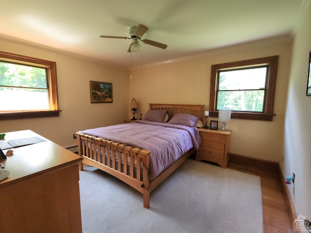 bedroom featuring ceiling fan, light hardwood / wood-style floors, ornamental molding, and a baseboard radiator