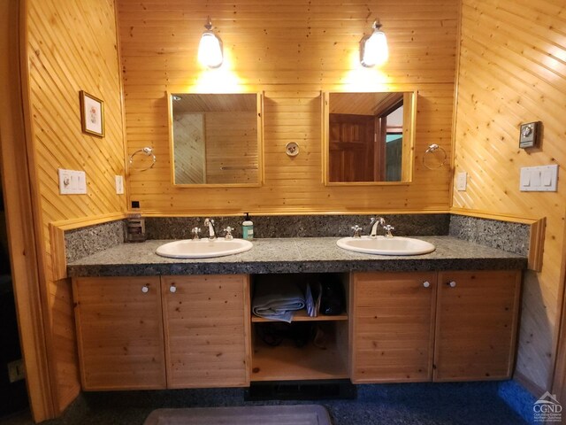 bathroom with wood walls and vanity