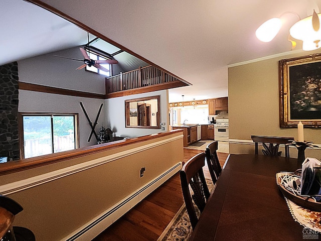 dining room featuring high vaulted ceiling, a baseboard heating unit, sink, hardwood / wood-style flooring, and ceiling fan