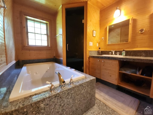 bathroom featuring vanity, wooden ceiling, a bathtub, and wooden walls