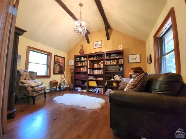 living area featuring hardwood / wood-style floors, plenty of natural light, beam ceiling, and a chandelier