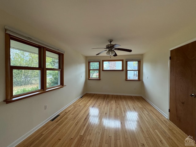 spare room featuring ceiling fan and light wood-type flooring