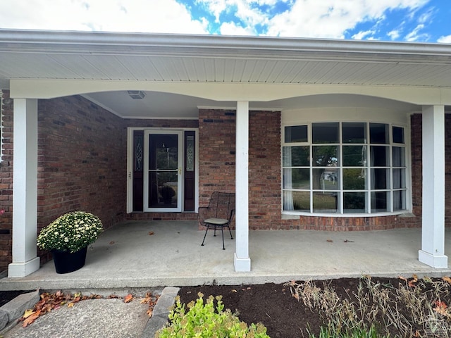 view of exterior entry with covered porch