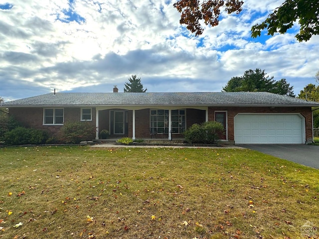 single story home featuring a front lawn and a garage