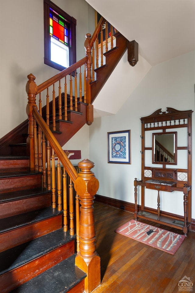 stairs featuring wood-type flooring