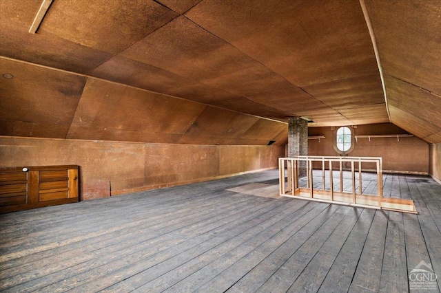 additional living space featuring dark hardwood / wood-style flooring and vaulted ceiling