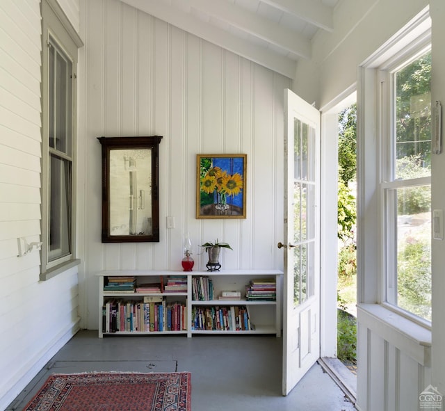 sunroom / solarium with vaulted ceiling with beams