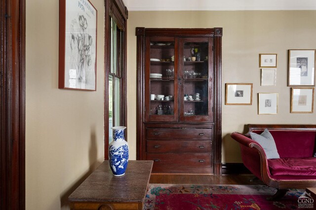 sitting room featuring beamed ceiling, wooden walls, and wooden ceiling