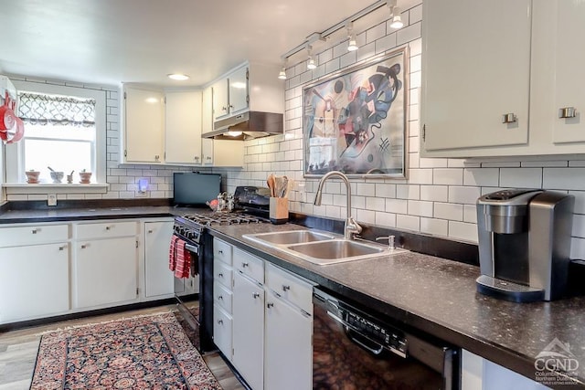 kitchen featuring a sink, dark countertops, black appliances, and under cabinet range hood