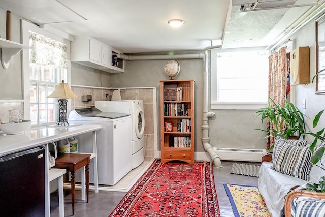 laundry room with washer and clothes dryer and baseboard heating