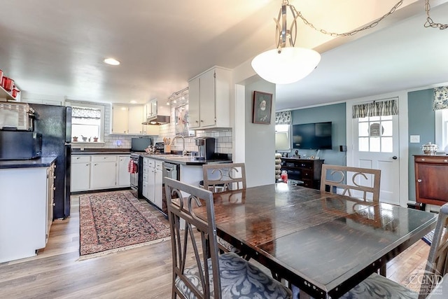 dining room featuring light wood-style floors and recessed lighting