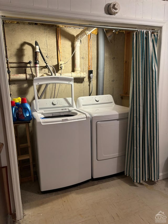 clothes washing area with washer and dryer and laundry area