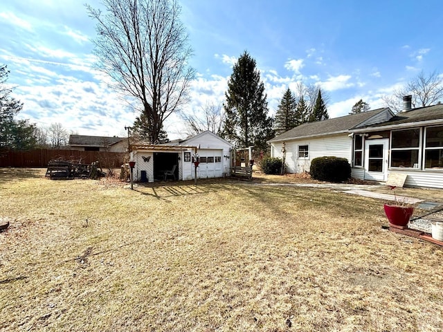 view of yard featuring an outbuilding and fence