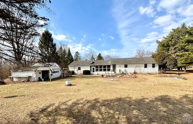 back of property with an outbuilding