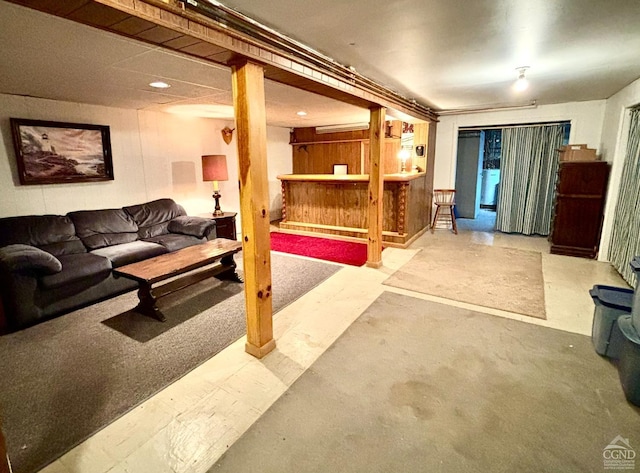 living area featuring a dry bar and concrete flooring