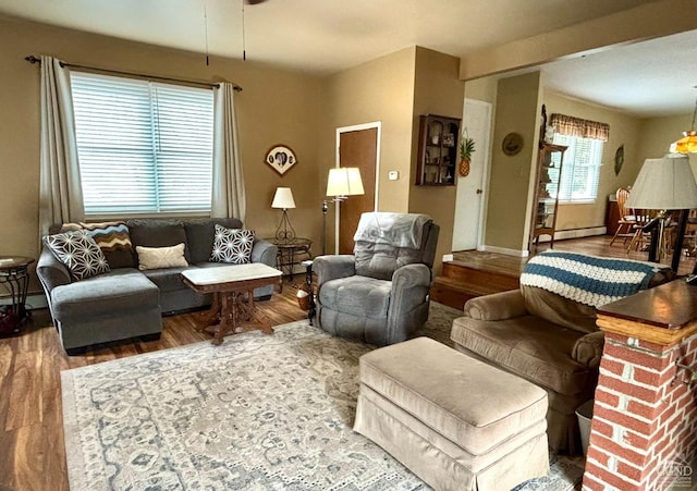 living area with baseboard heating and wood finished floors