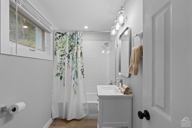 bathroom with vanity, wood-type flooring, and shower / tub combo