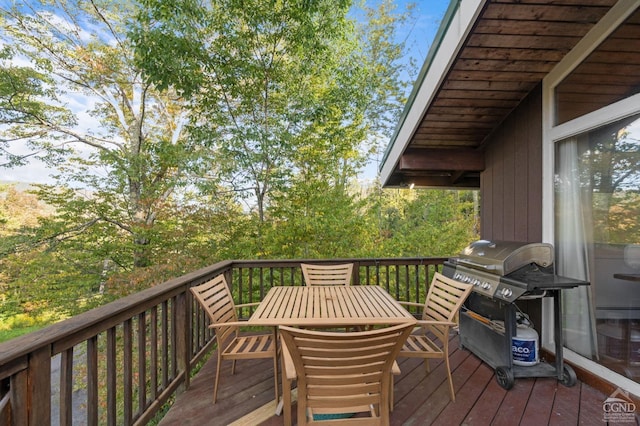 wooden deck featuring a grill