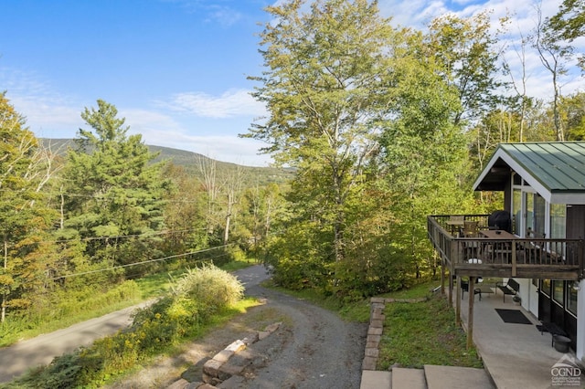 exterior space with a deck with mountain view