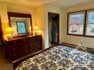 bedroom with ornamental molding and a closet