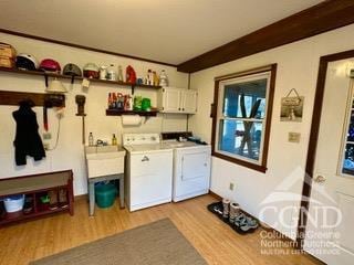 interior space with washing machine and clothes dryer, cabinets, and light hardwood / wood-style floors