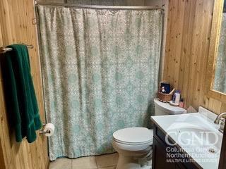 bathroom featuring tile patterned floors, vanity, and toilet