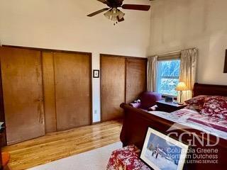 bedroom featuring ceiling fan and multiple closets