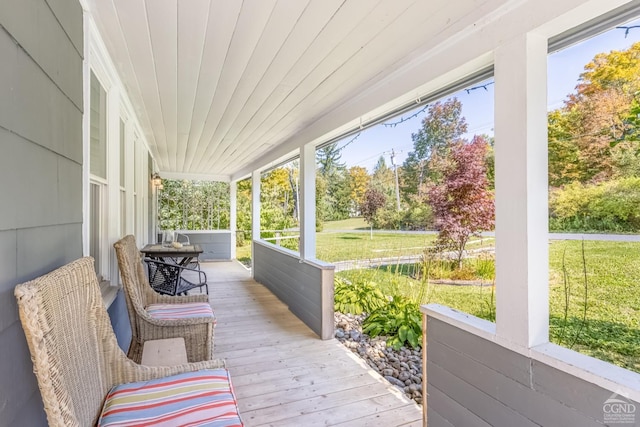 wooden deck with a yard and covered porch