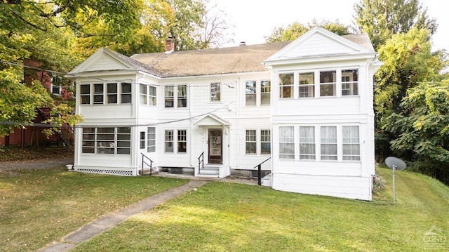 rear view of house with a yard