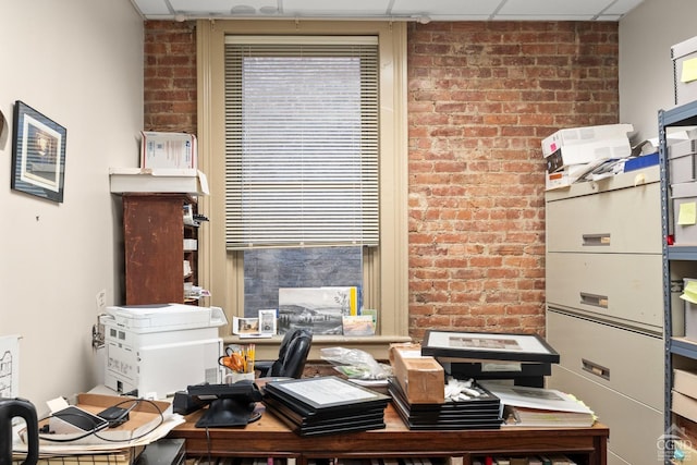 office with brick wall and a paneled ceiling