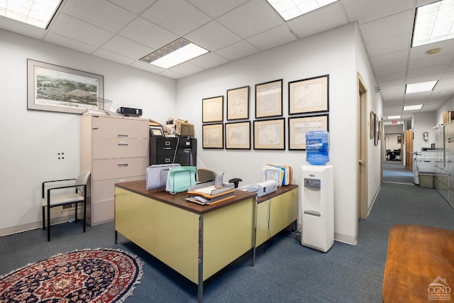 home office with a paneled ceiling, baseboards, and carpet
