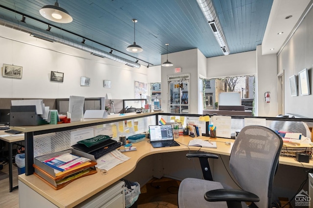 office space featuring rail lighting and wood finished floors