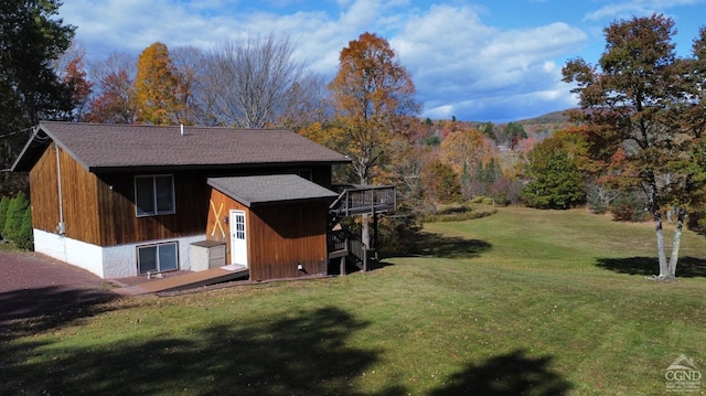 exterior space with a lawn and a wooden deck