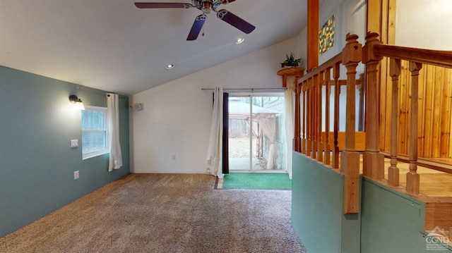 unfurnished living room featuring ceiling fan, carpet, and lofted ceiling