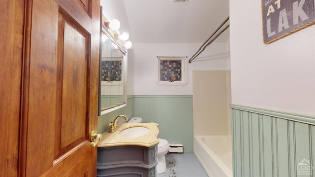 full bathroom with vanity, a baseboard radiator, shower / bathtub combination, and toilet