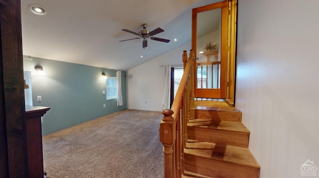 interior space with carpet flooring, ceiling fan, and vaulted ceiling