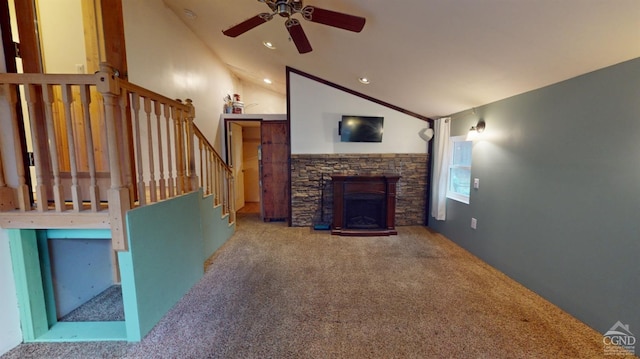 carpeted living room featuring ceiling fan, a stone fireplace, and high vaulted ceiling