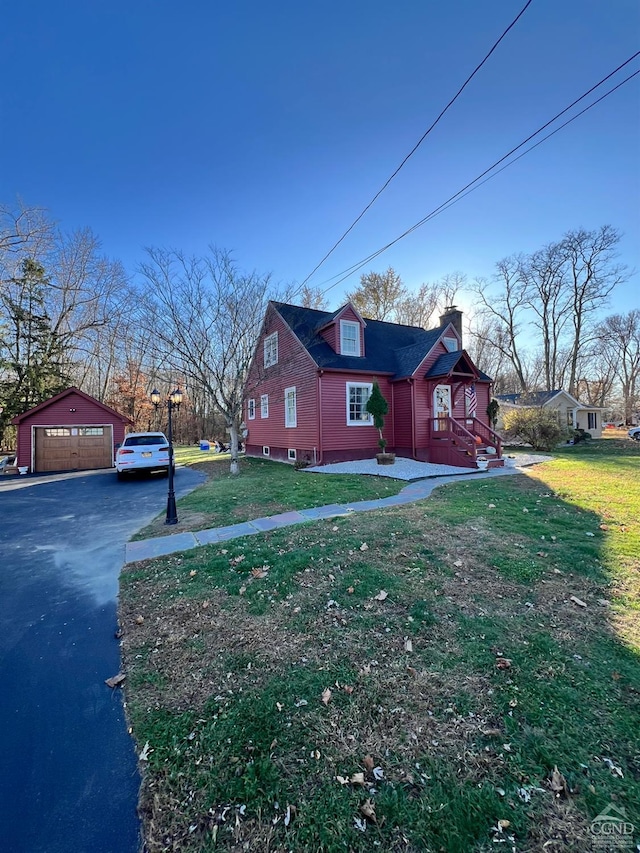 view of property exterior featuring a lawn, an outbuilding, and a garage