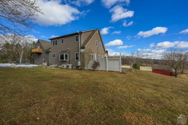 rear view of house with a yard and a deck