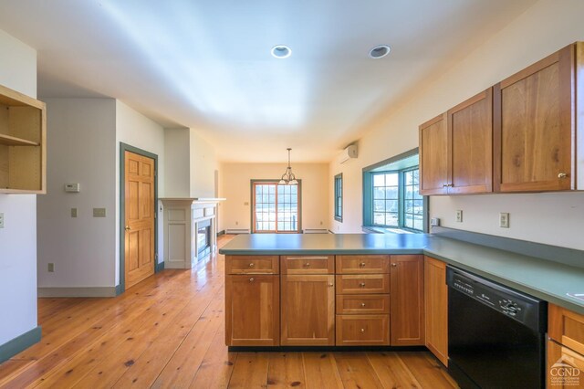kitchen with decorative light fixtures, black dishwasher, light hardwood / wood-style floors, and kitchen peninsula
