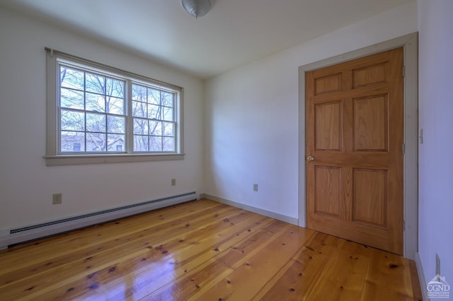 spare room with light hardwood / wood-style floors and baseboard heating
